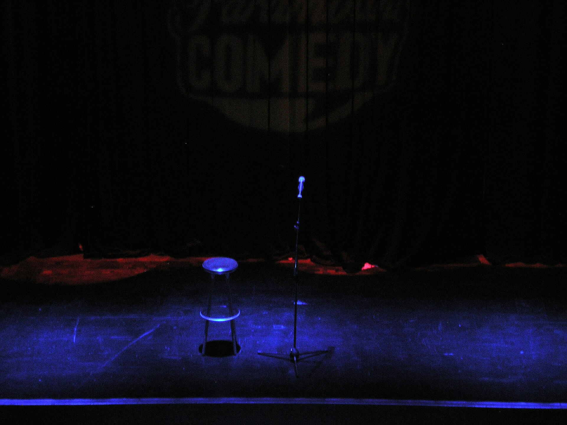 Stand-up comedy stage with microphone and stool