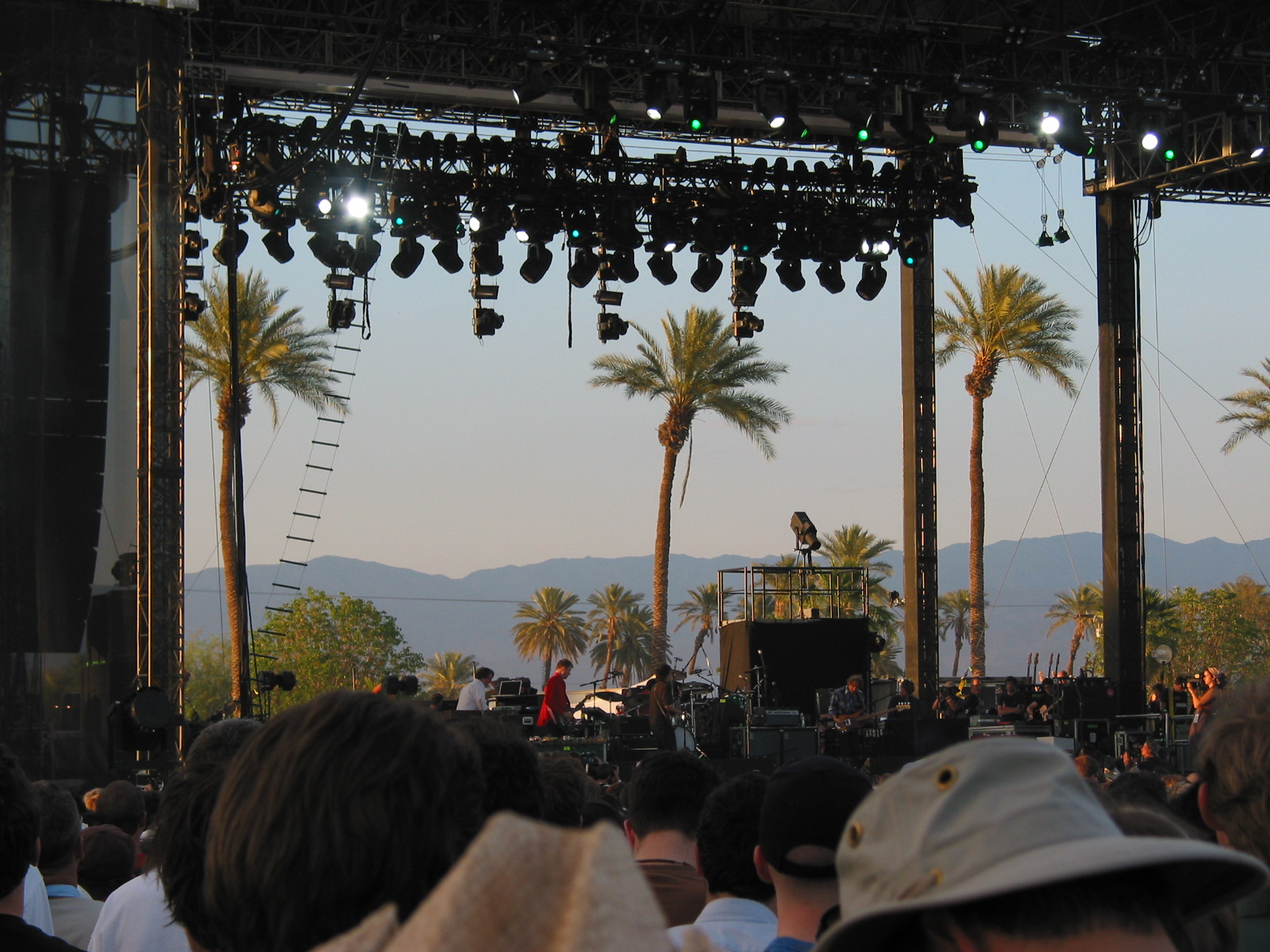 Massive outdoor music festival at golden hour